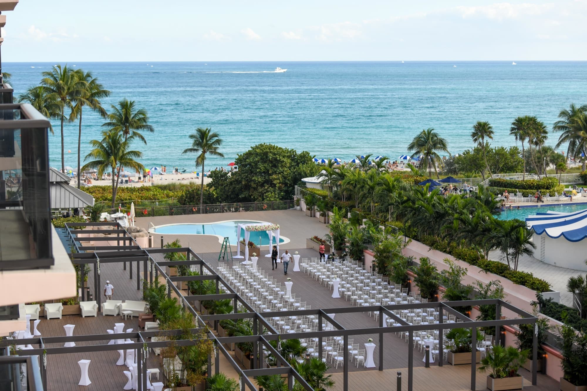 The oceanfront deck at The Alexander Hotel, white chairs facing the Atlantic